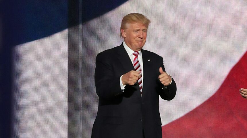 Donald Trump beside man in black suit