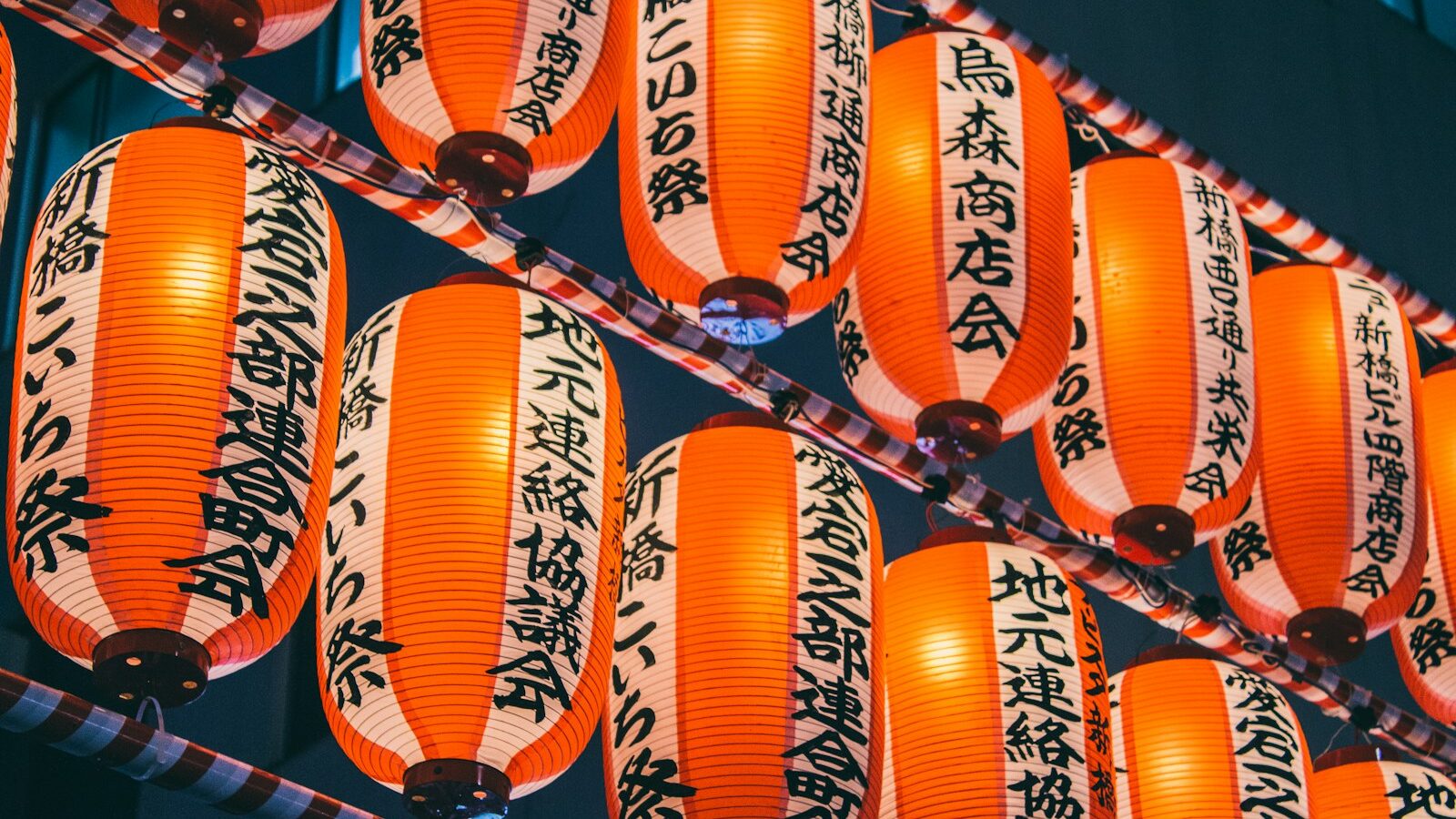 orange paper lanterns on black metal frame