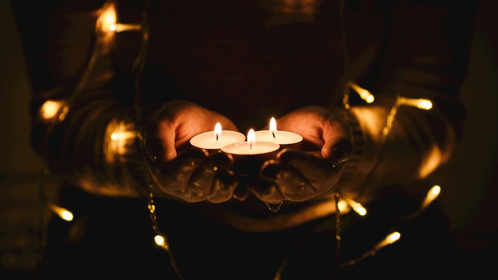 selective focus photography of three lit tealight candles