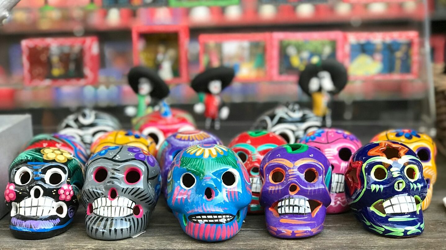 multi-colored sugar skull figurines